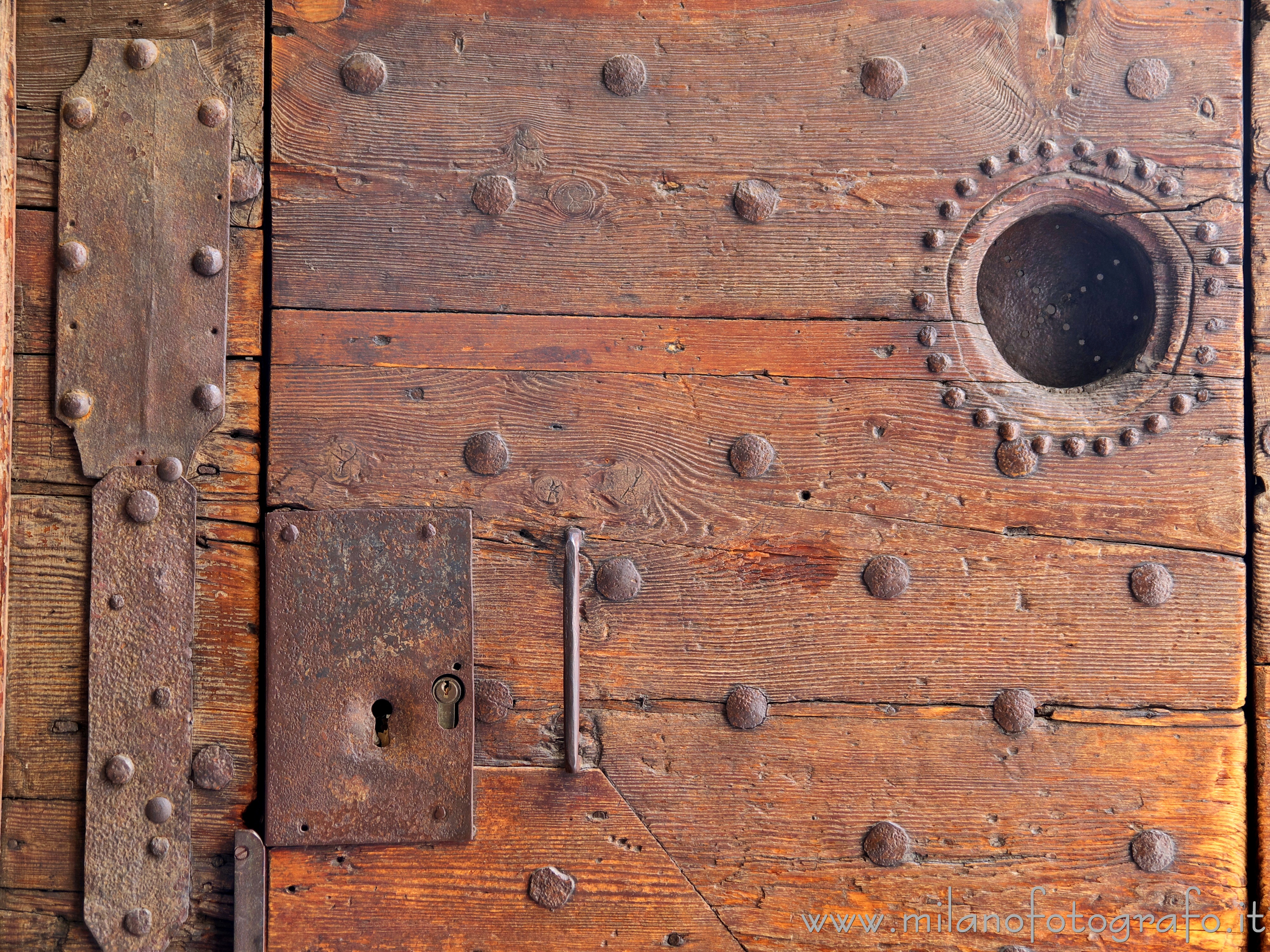 Milan (Italy) - Detail of the pedestrian door to the court of the Church of Santa Maria del Carmine